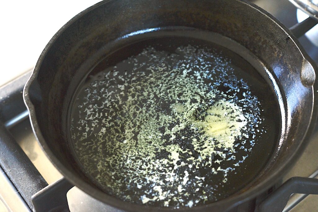 cast iron skillet with melted butter