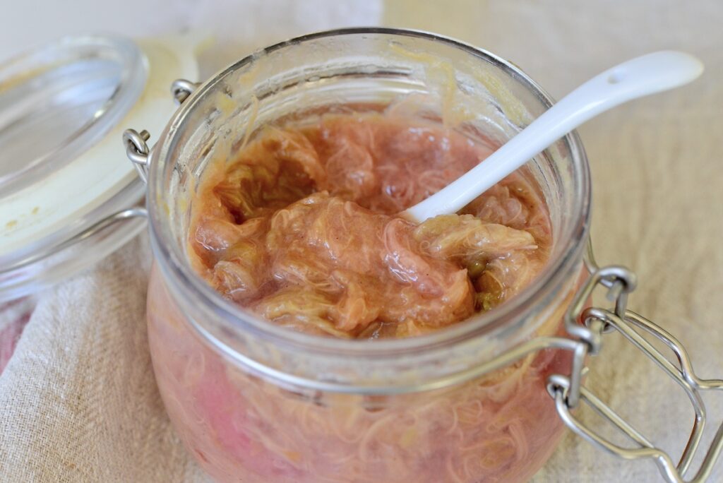 jar of rhubarb jam with white spoon