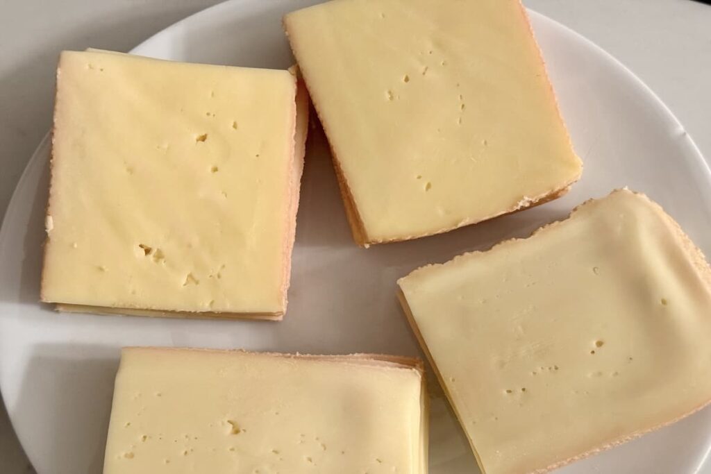 slices of raclette cheese on plate