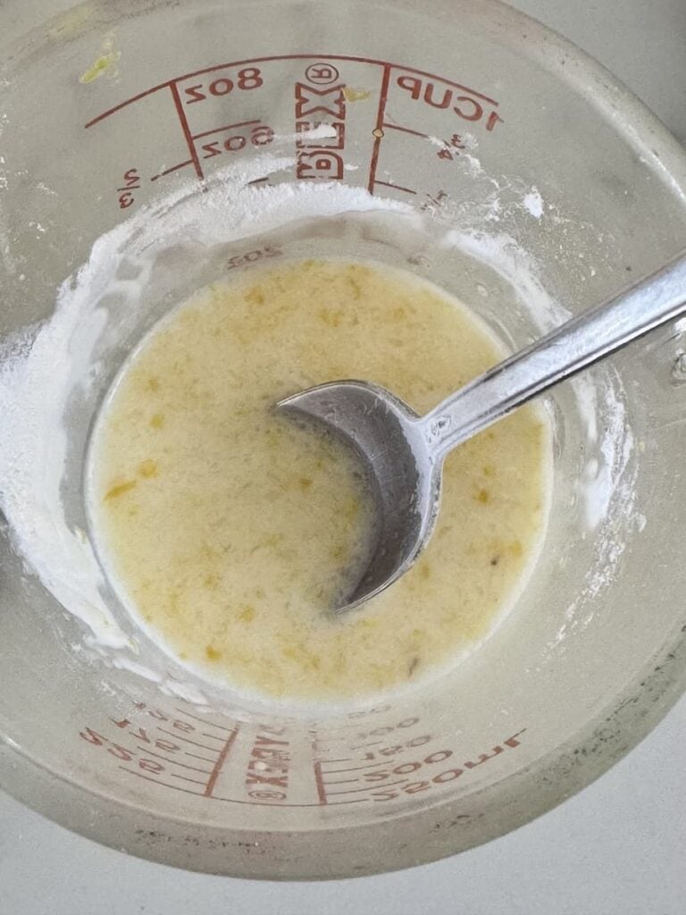 spoon stirring cornstarch into lemon juice