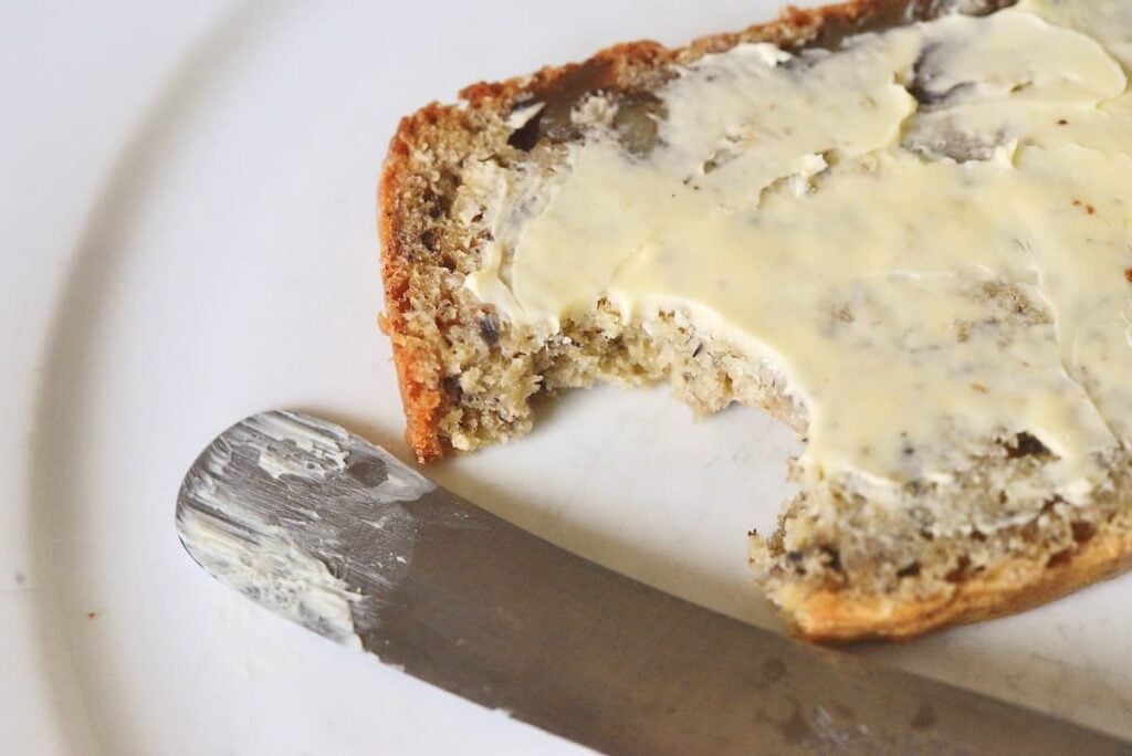 slice of banana bread with butter and bite taken out