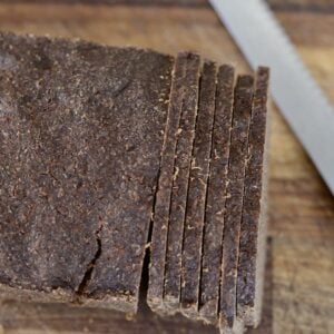 loaf of pumpernickel bread with slices cut