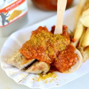 small plate with sausage pieces with curry ketchup, French fries, and mayonnaise