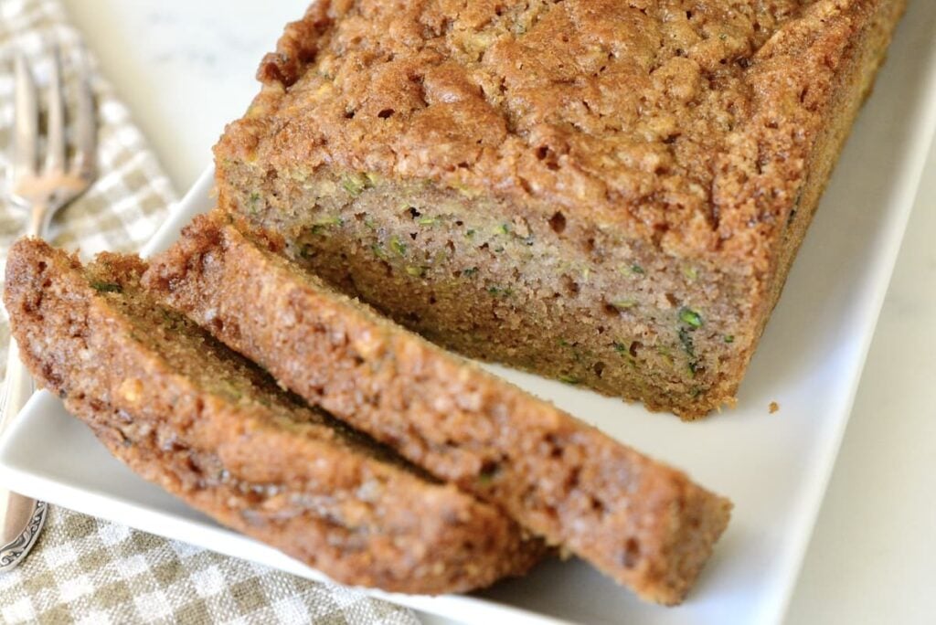 slices and loaf of zucchini bread on platter