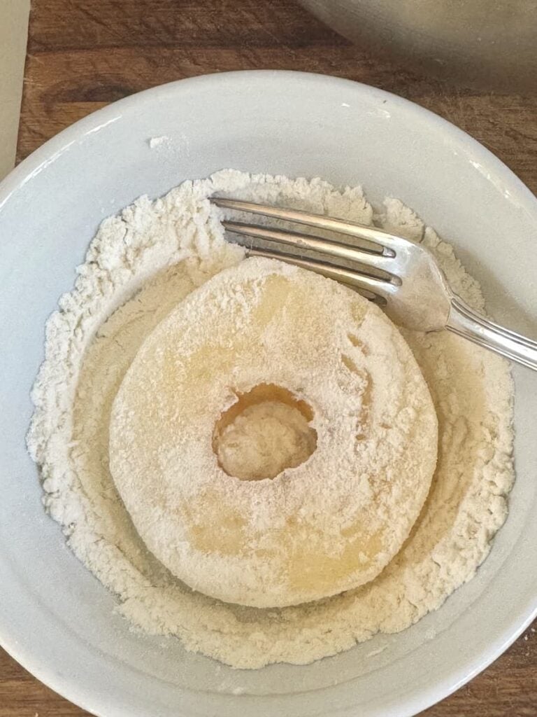 apple ring coated in flour in small bowl