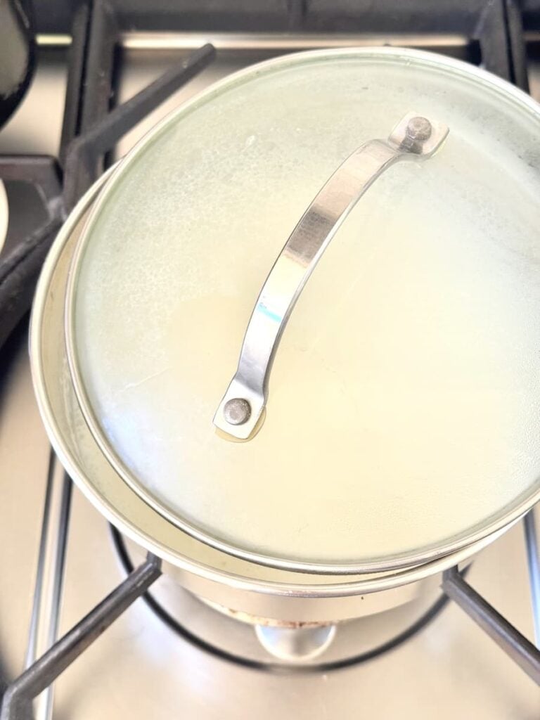 saucepan with cracked lid on stovetop