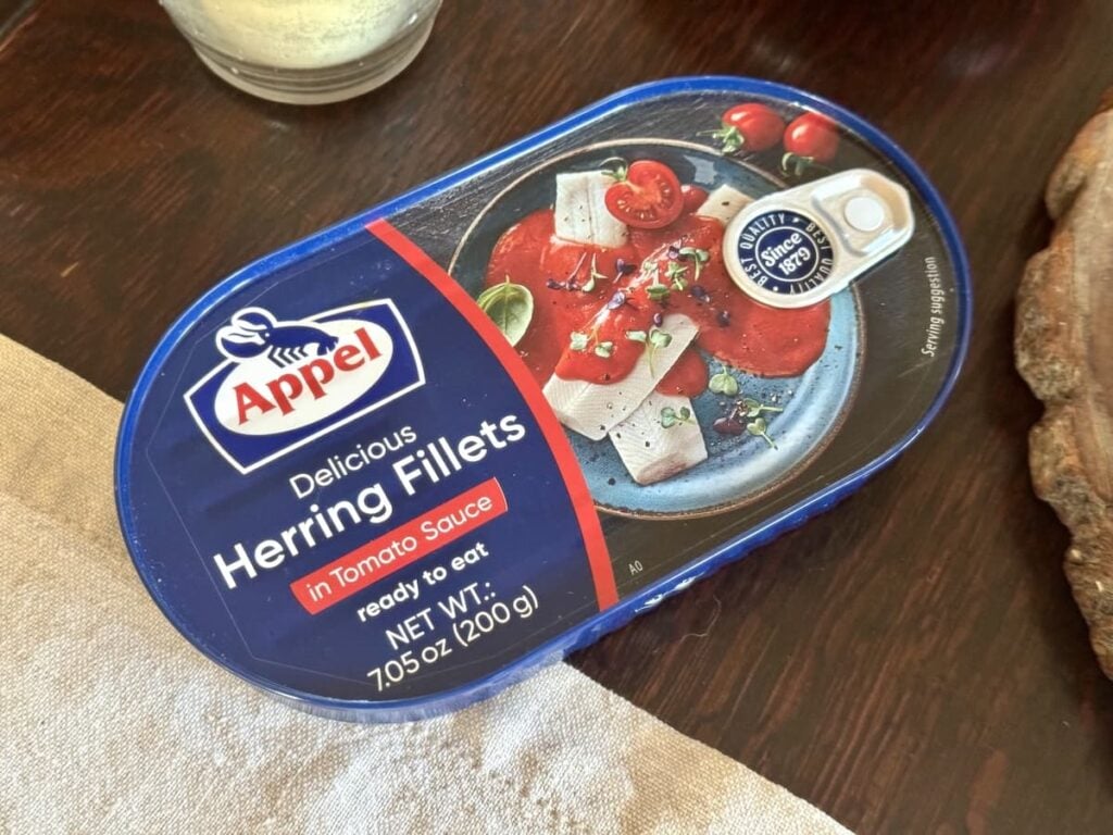 can of German herring fillets in tomato sauce on table