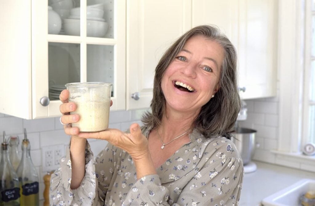 Anja holding a jar of sourdough starter