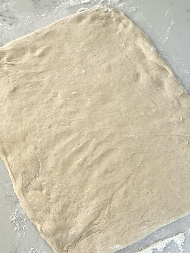 dough rolled out to a rectangle on kitchen counter