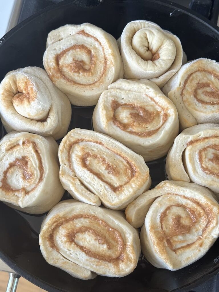 unbaked cinnamon rolls in cast iron skillet