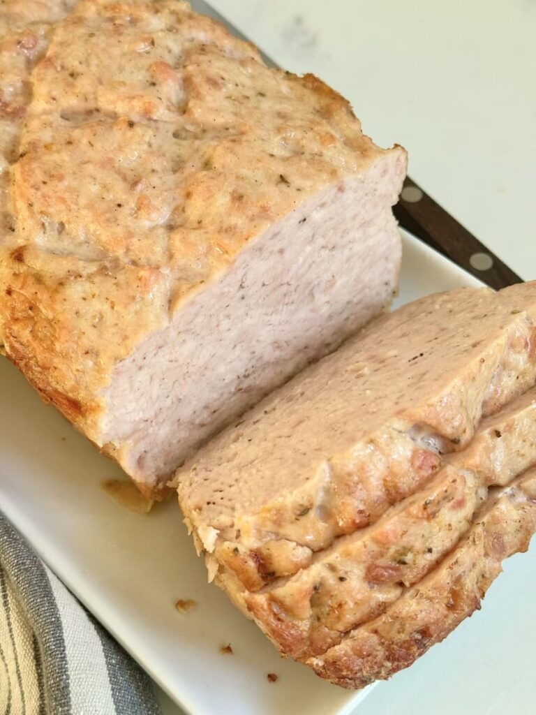 loaf of German Leberkaese on plate with slices cut off