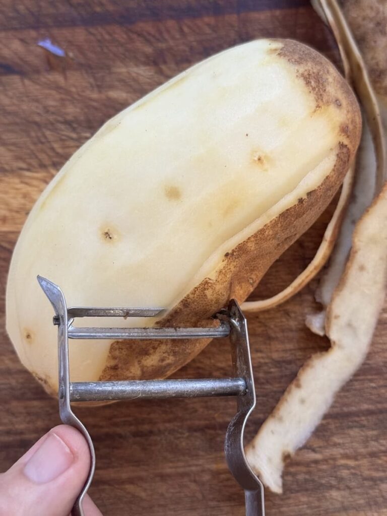 vegetable peeler peeling large potatoe