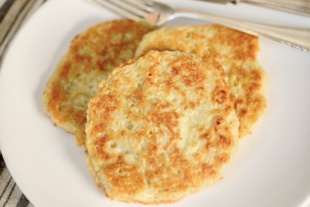 Kartoffelpuffer on plate with utensils