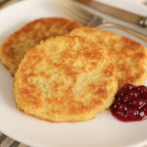 German potato cakes on plate with dollop of lingonberry jam