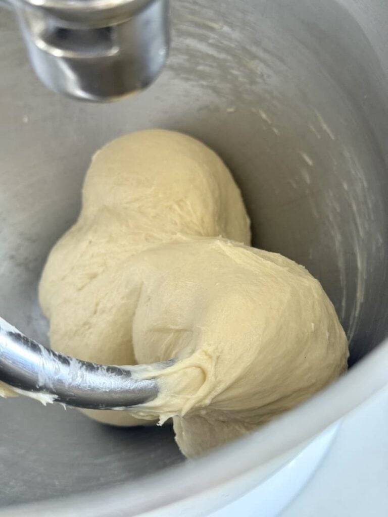 dough ball in bowl of stand mixer with dough hook