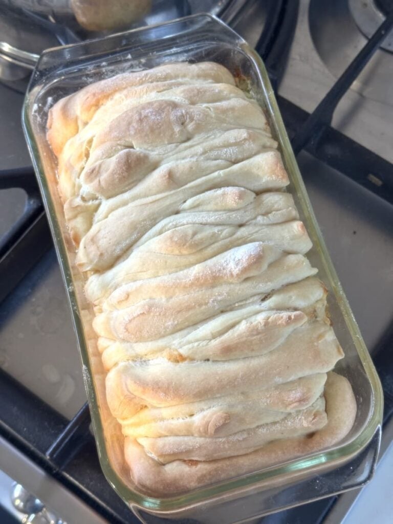 baked pull apart bread in glass loaf pan